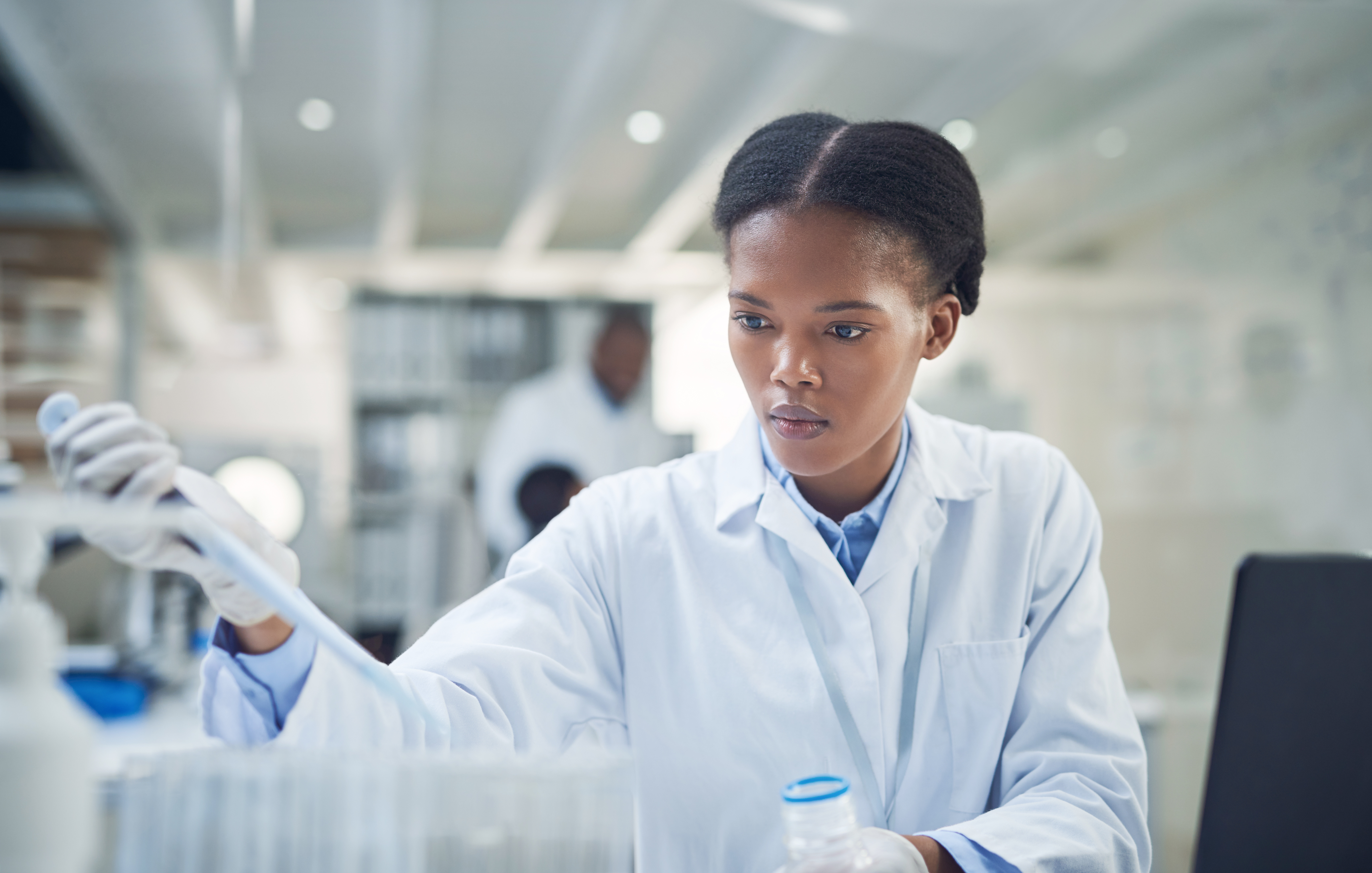 Shot of a young scientist working in a lab